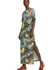 Woman wearing a patterned dress on a white background