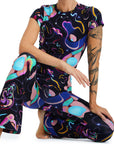 Person wearing a colorful, abstract-patterned outfit on a white background