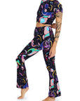 Person wearing a colorful patterned outfit on a white background