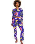 Woman wearing a colorful patterned outfit on a white background