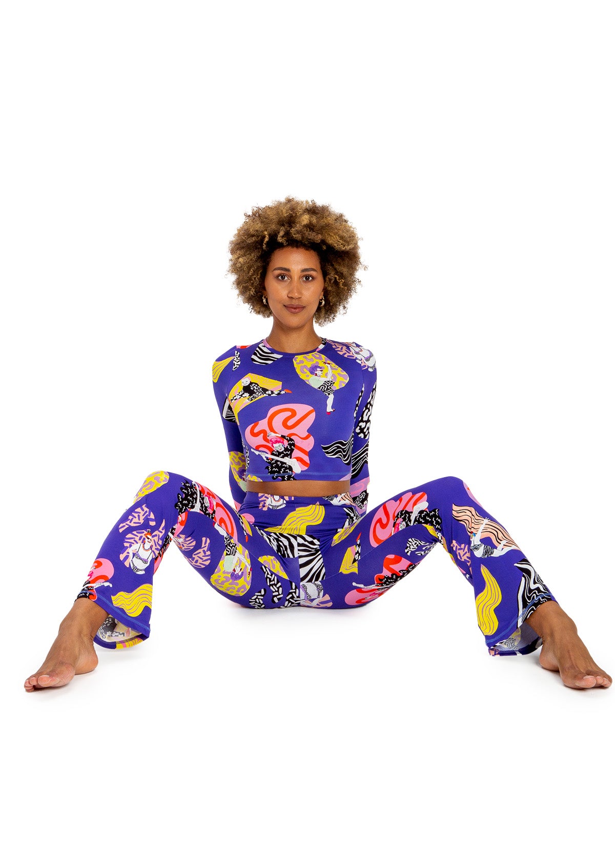 Woman wearing a colorful patterned outfit on a white background