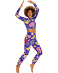 Woman wearing a colorful outfit with a vibrant pattern on a white background