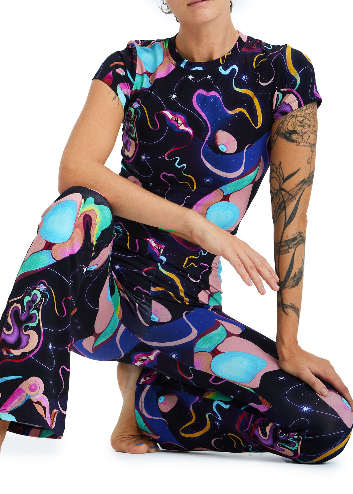 Person wearing a colorful, abstract-patterned outfit on a white background
