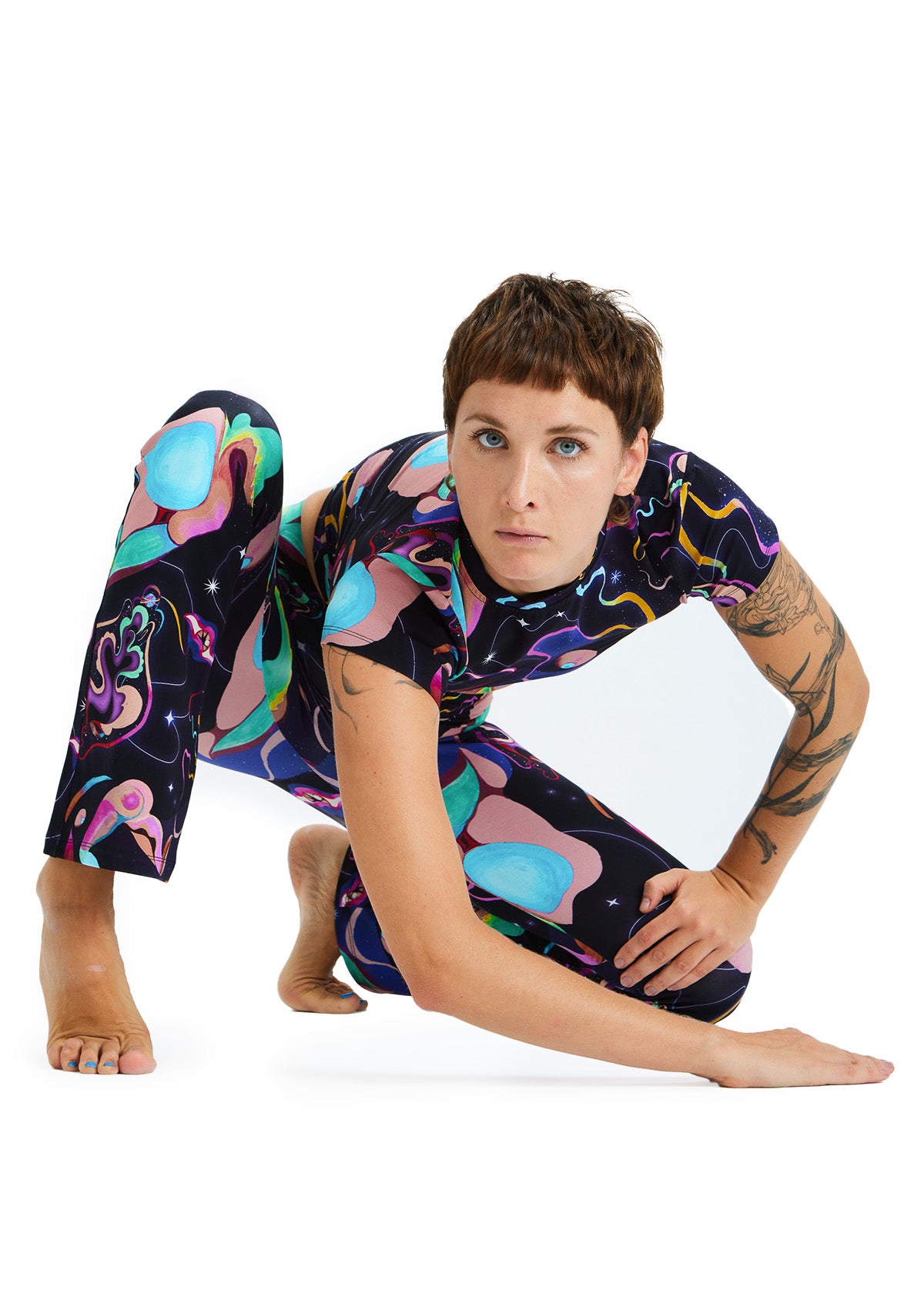 Person wearing a colorful, patterned outfit on a white background
