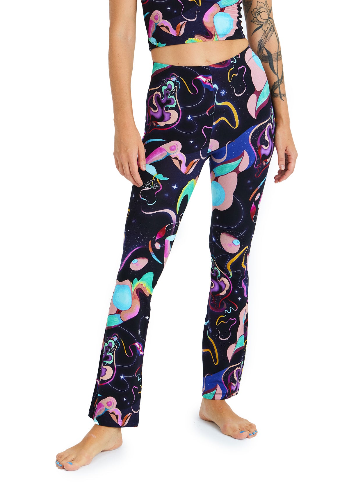 Person wearing colorful abstract-patterned leggings on a white background